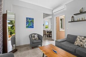 a living room with a couch and a table at Villa Blue Dreams in Maleme in Ayiá +18 photos