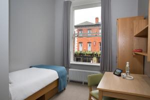 เตียงในห้องที่ Trinity College - Campus Accommodation