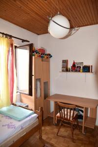 a bedroom with a desk and a bed and a table at Valdanos in Ulcinj