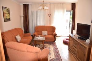 a living room with two chairs and a television at Valdanos in Ulcinj +11 photos