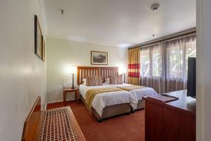 a hotel room with a bed and a television at Knysna Log-Inn Hotel in Knysna +50 photos