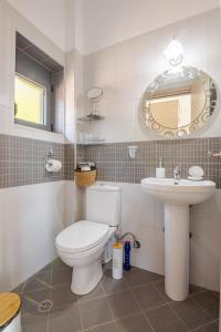 a bathroom with a toilet and a sink at Aurora Spinalonga Garden Cottage in Chavgas +45 photos