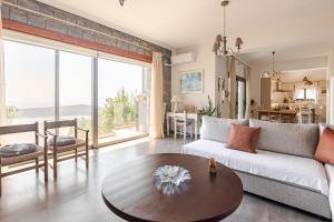 a living room with a couch and a table at Aurora Spinalonga Garden Villa with Jacuzzi Pool in Chavgas