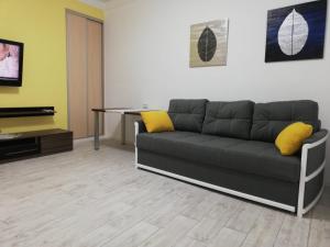 a living room with a couch and a table at Austrian Lviv Apartments in Lviv