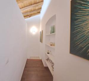 a hallway with white walls and a blackboard on the wall at Noctua Estepona Old Town 025 in Estepona +7 photos
