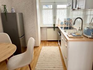 a kitchen with a stainless steel refrigerator and a table at Residenz zu Caub - Rheinblick in Kaub