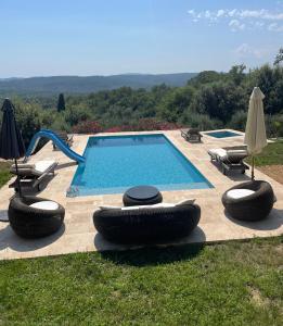 a swimming pool with two large tires around it at Maisonnette au calme in Montauroux