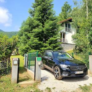 a black car is parked at a toll booth at WOLF'S PLANE Luxury Isolated Mountain House for Digital Nomads in Fojnica