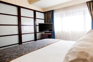 Postel nebo postele na pokoji v ubytování Hotel Le Châtelain