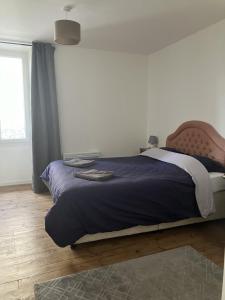 a bedroom with a large bed with a blue comforter at Apartment Centre Historic in Marvejols