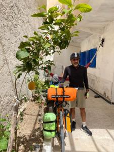 a man is standing next to a bike at Hostel le Rhumel in Constantine