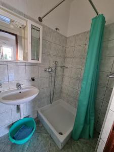 a bathroom with a sink and a shower and a tub at Apartmani Bada in Pakoštane +46 photos