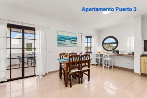 a kitchen and dining room with a table and chairs at Apartamentos Puerto 1, 2 y 3 in Playa Blanca +4 photos