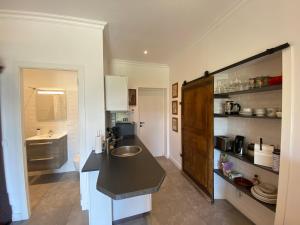 a kitchen with a sink and a counter top at Maison du Lac le Studio in Talloires