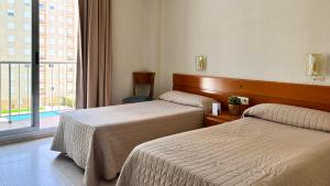 Postel nebo postele na pokoji v ubytování Hotel Safari