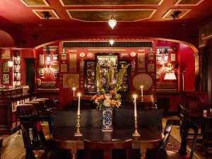 a restaurant with a table with candles on it at The Zetter Marylebone in London