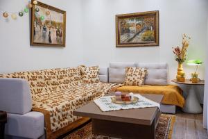a living room with a couch and a table at Myrtilli Cottages Pelion in Áno Lekhónia