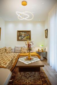 a living room with a couch and a table at Myrtilli Cottages Pelion in Áno Lekhónia