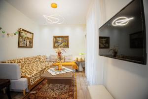 a living room with a couch and a table at Myrtilli Cottages Pelion in Áno Lekhónia