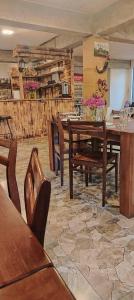 a dining room with a wooden table and chairs at Family Hotel Twins in Ushguli
