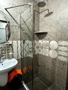 a bathroom with a shower and a sink at House near boulevard and sea in Batumi