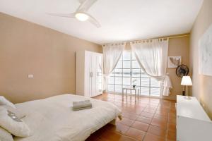 a bedroom with a bed and a large window at Saint Maxime in Adeje +20 photos