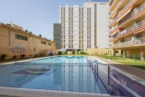 a large swimming pool in front of a building at Apartamento Primera Línea De Mar in Malgrat de Mar