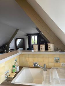 a kitchen sink in the middle of a attic at Apple garden in Victot-Pontfol