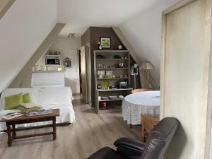 a living room with a bed and a table at Apple garden in Victot-Pontfol