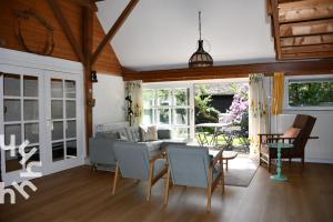 a living room with a couch and a table and chairs at OV598 6P holiday home with fenced garden by the water in Kalenberg in Kalenberg