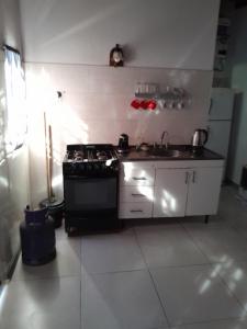 a kitchen with a stove and a sink at La lechon in Santa Teresita