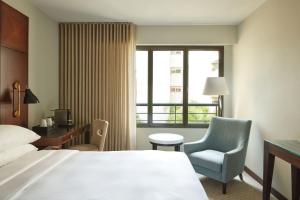 a hotel room with a bed and a chair and a window at Hyatt Regency Nice Palais de la Méditerranée in Nice