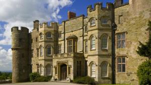 an old stone building with a gate in front at The Piggery in Yarpole