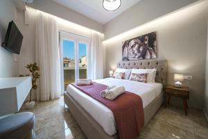 een slaapkamer met een groot bed met handdoeken erop bij Akalli Luxury Living in Heraklion