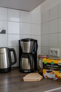a coffee maker on a counter with a box of coffee at Hip & Beautiful City Apartment in Berlin