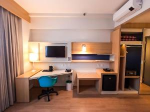 Stay Inn Santos Sua acomodação com cara de Hotel的电视和/或娱乐中心