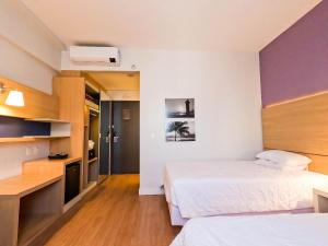 Stay Inn Santos Sua acomodação com cara de Hotel客房内的一张或多张床位