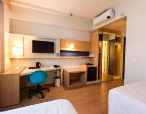 Stay Inn Santos Sua acomodação com cara de Hotel的电视和/或娱乐中心