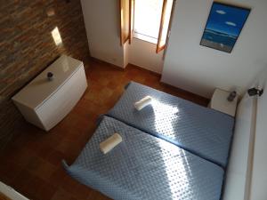 Postel nebo postele na pokoji v ubytování Casa Das Romãs
