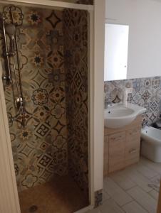 a bathroom with a shower and a sink at Le Casette di Nonna Rosa in Fontanarossa Catania Airport in Catania +36 photos