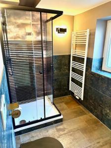 a bathroom with a shower with a glass door at Pension Victoria Halberstadt in Halberstadt +127 photos