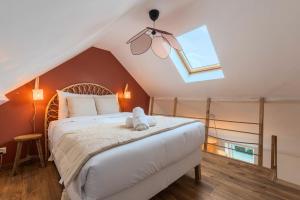 a bedroom with a bed with a stuffed animal on it at 3 bedroom house with garden, near tram in Mouvaux +28 photos