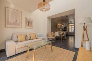 a living room with a couch and a table at 3 bedroom house with garden, near tram in Mouvaux