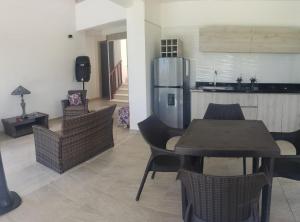a kitchen and dining room with a table and a refrigerator at Villa Lucero 143 in Los Santos