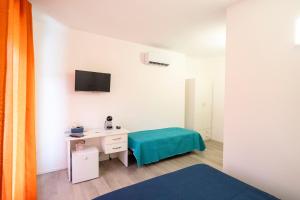 a room with a desk and a tv on the wall at Prestige House 7 in Scalea
