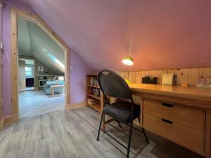 a desk with a chair in a room at Endeavour Guest House in Aberdeen