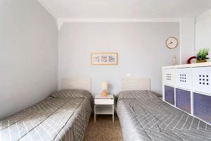Łóżko lub łóżka w pokoju w obiekcie Luminoso apartamento en la Plaza del Charco