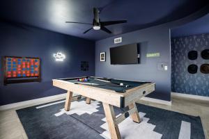 a room with a pool table and a tv at Basketball Court Heated Pool Mini Golf & More in Glendale