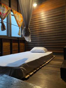 a bedroom with a bed in a room with windows at Chest's Place in Bangkok +13 photos