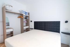 a bedroom with a bed and a black tiled wall at E&J Mare e Relax in Sanremo